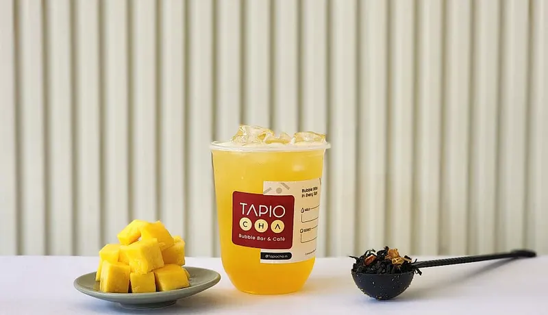Mango drink in a Tapiocha cup with fresh mango