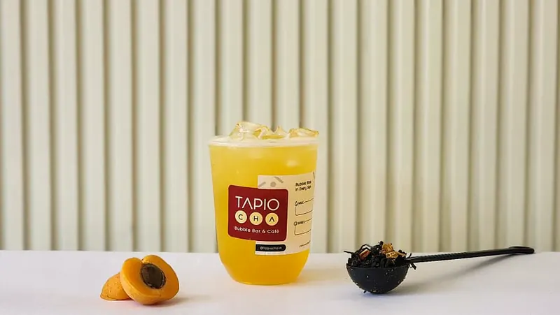 Mango fruit tea in a Tapiocha cup with apricots
