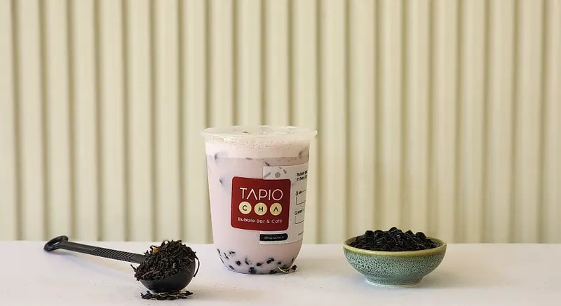 A Tapiocha milk tea with a scoop of tapioca pearls