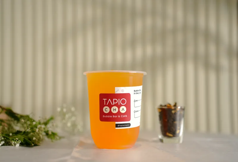 An orange fruit tea in afternoon sun at Elante