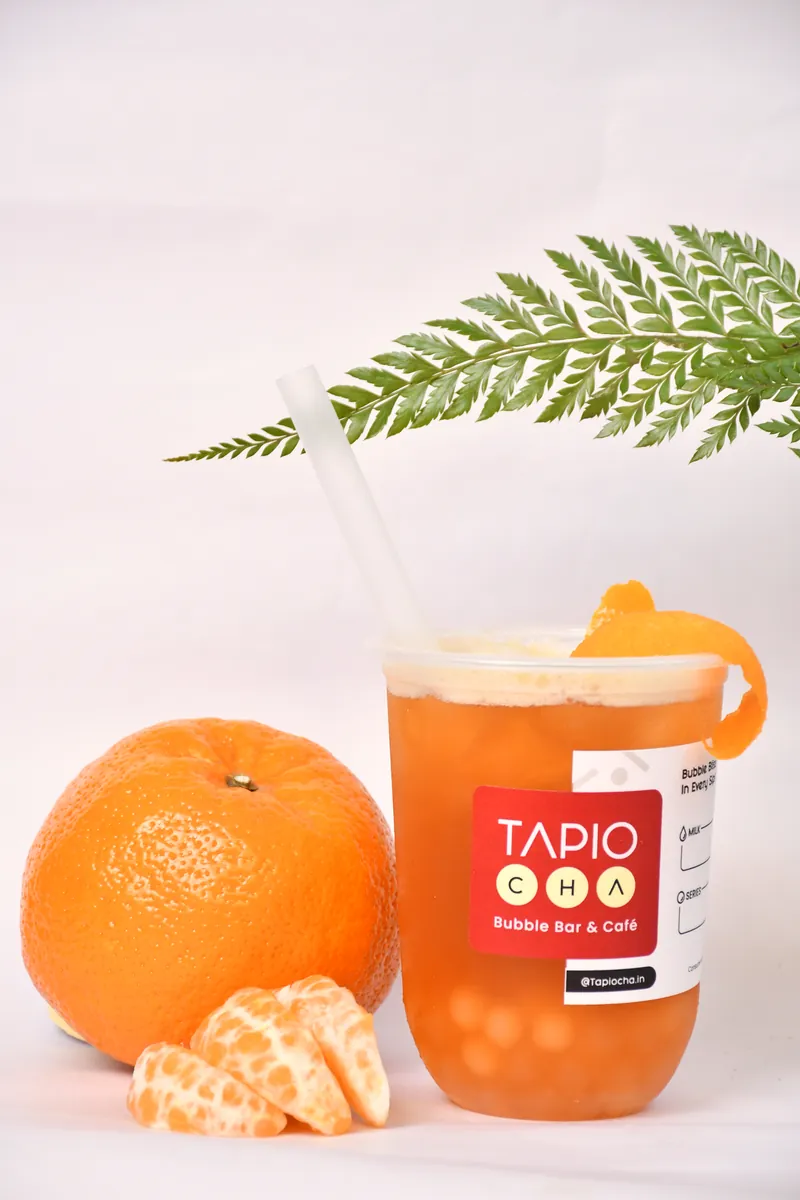 Orange fruit tea with oranges and fern